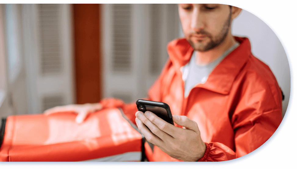 delivery worker using smart phone holding package