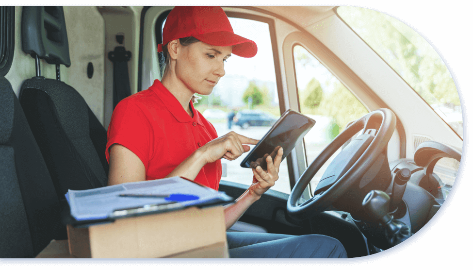delivery driver sitting in truck using smart tablet