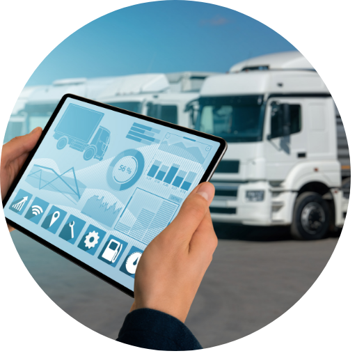 hands holding smart tablet showing transportation and logistics information with a background of semi trucks