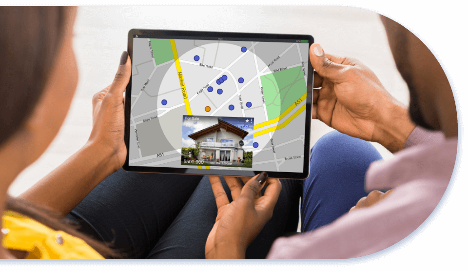 hands holding smart tablet showing a map of real estate listings for sale