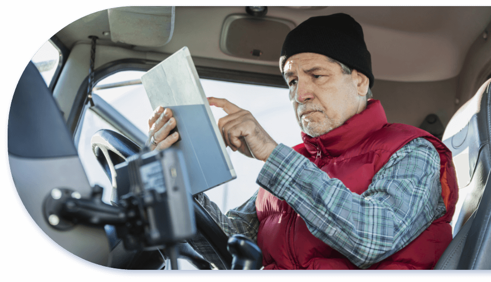 man in truck cab using smart tablet