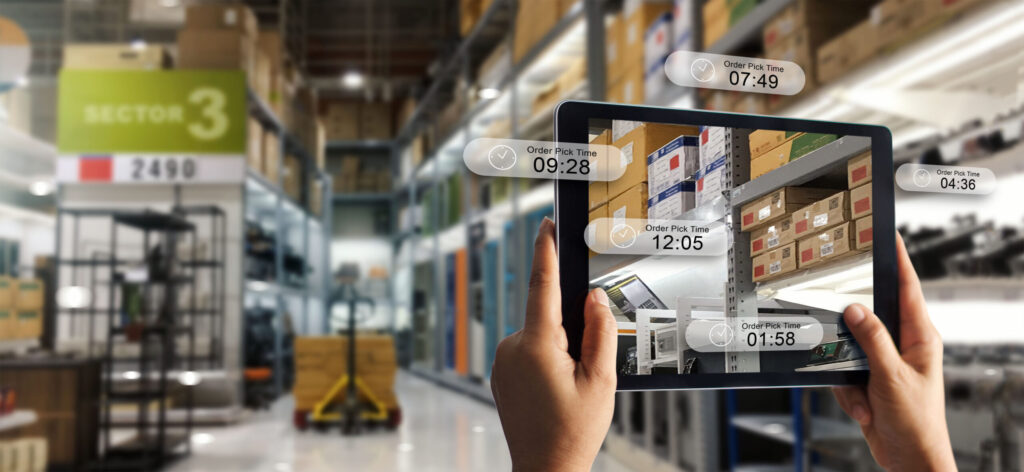 hand holding digital tablet using augmented reality to display order information with storage factory background