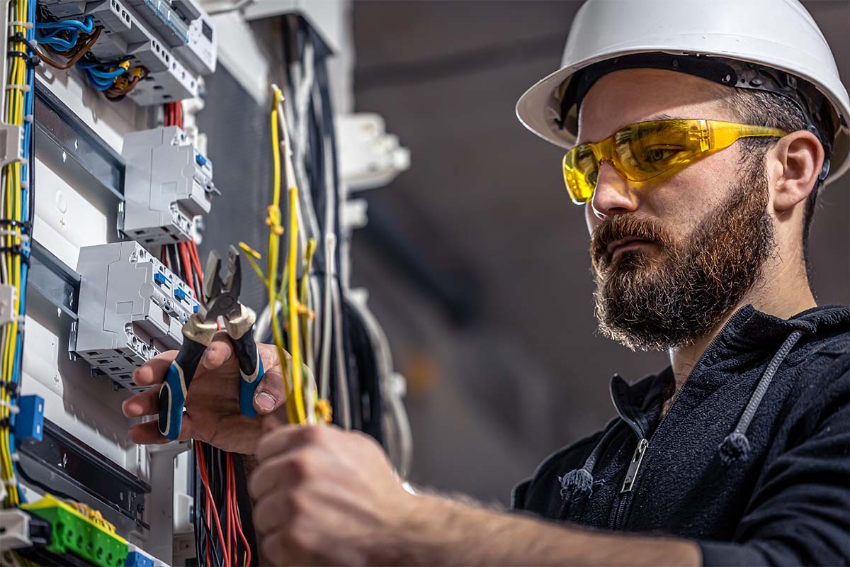 worker with hard hat on at electrical box