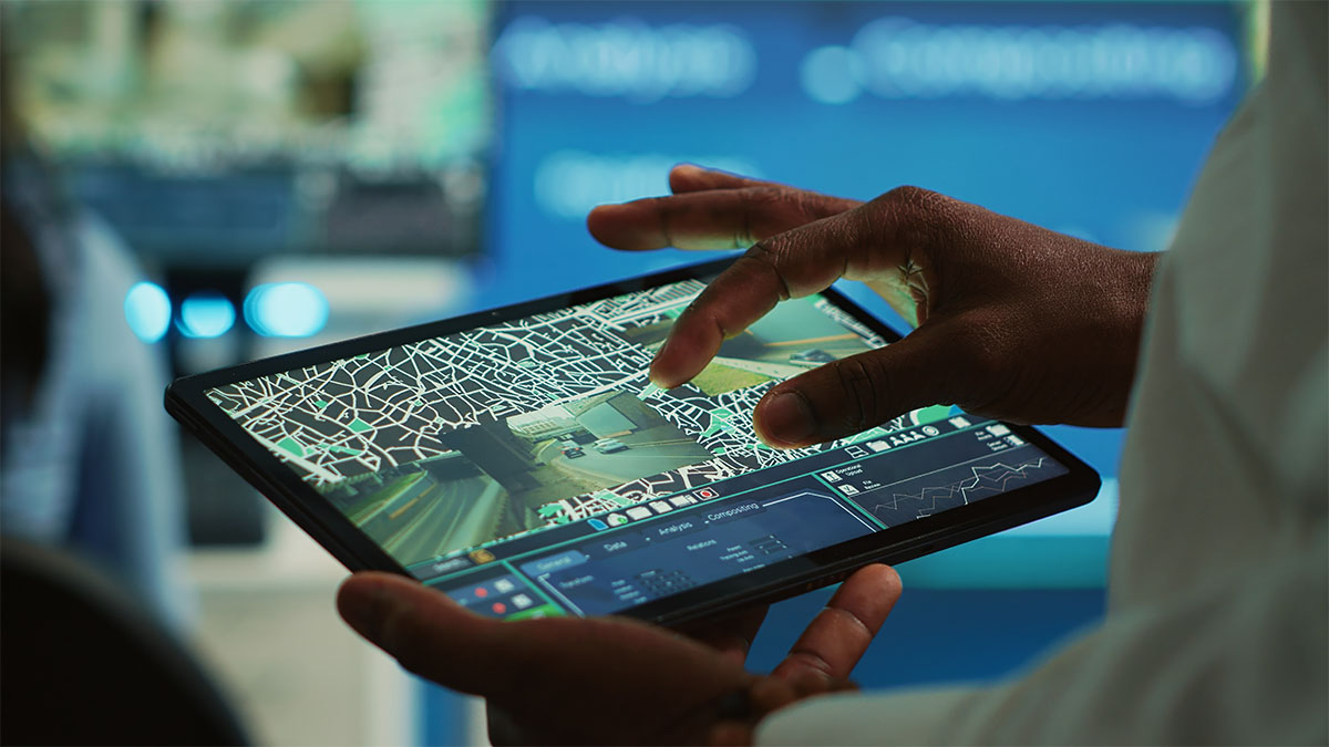 hands holding smart tablet with map on screen