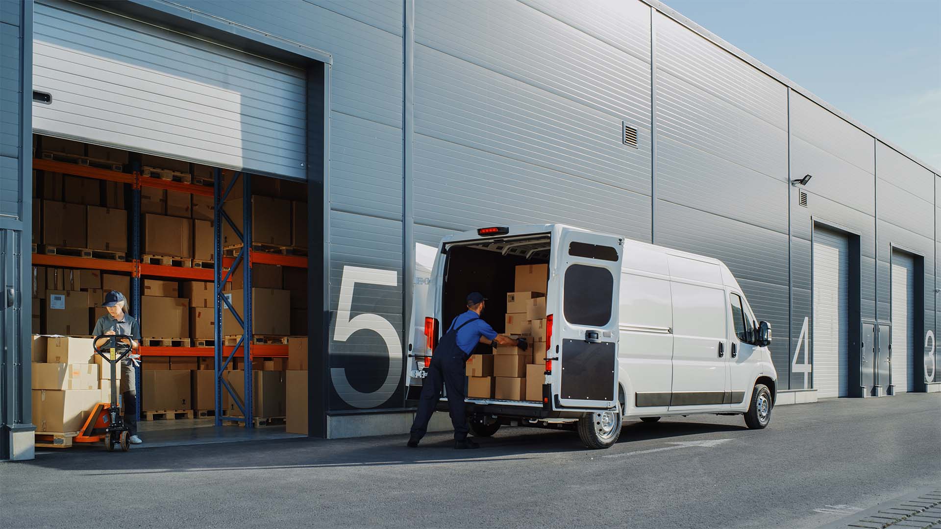 workers loading a delivery van with packages