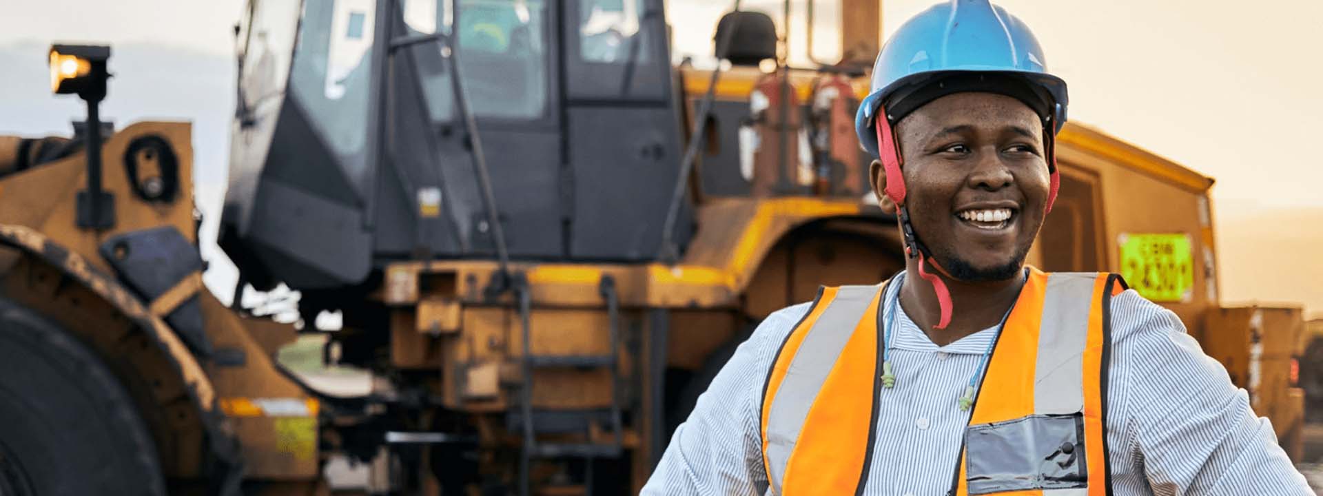 construction worker in front of equipment